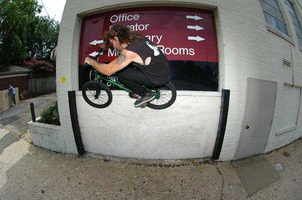 Kenny Horton, shredding high a peg grind.