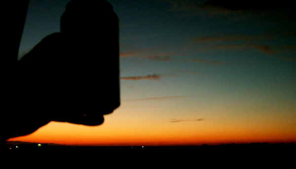 this is a beautiful shot of a beverage silouhette out of a moving van window on a cross country drive...