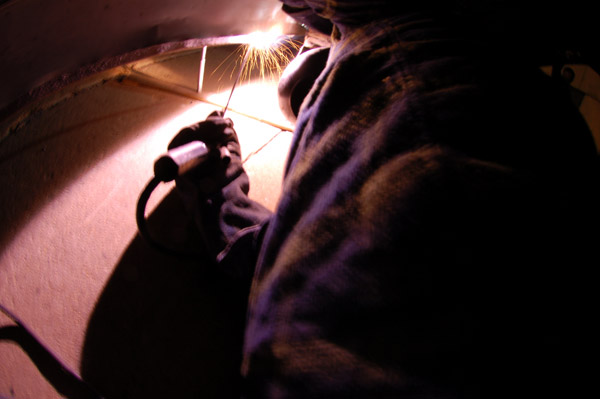 John Corts stick welding the bus back together.