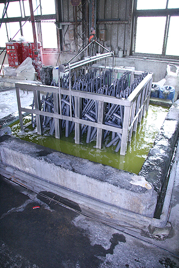 Frames being dipped in a bath before paint.